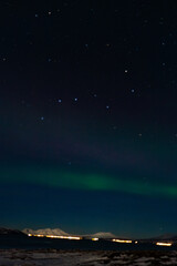 Fototapeta na wymiar Northern lights night in Tromso in Norway ona cold night in winter 