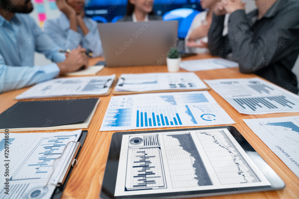 Poster focus financial dashboard paper showing graphs and chart with blurred background of diverse business