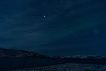 Northern lights night in Tromso in Norway ona cold night in winter  - obrazy, fototapety, plakaty