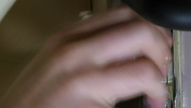Hand of man which tries to open door lock with pick. Timelapse closeup