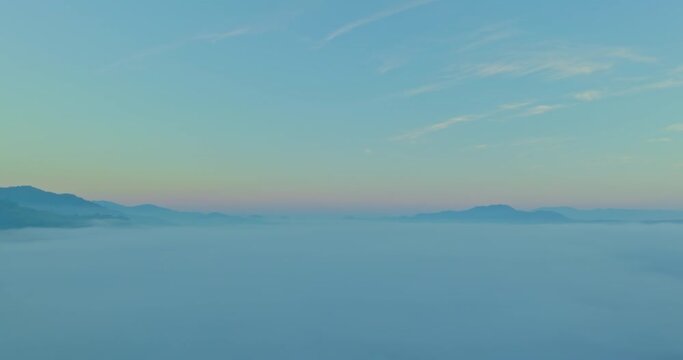 Aerial view scenery beautiful sunrise above the sea of mist in front Thi Lor Su waterfall..There is a golden yellow glow on the horizon caused by the radiant light of the sun..colorful sky of sunrise