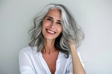 Fototapeta premium A radiant lady's infectious smile and flowing hair complement the intricate layers of her clothing as she confidently poses against a textured wall, capturing the essence of feminine grace and poise 
