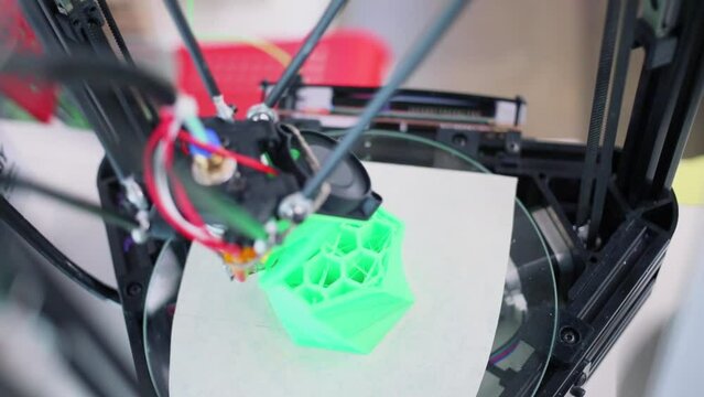 3D printer makes green plastic form with cells, closeup