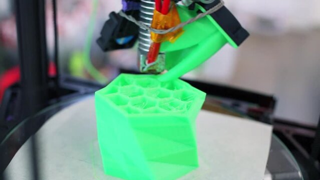 3D printing of green plastic form with cells, closeup
