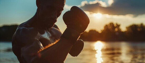 Male kickboxer shadow boxing outdoors, close-up. - obrazy, fototapety, plakaty