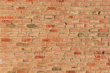 Warm Glow: Salmon-Colored Brick Wall Background.