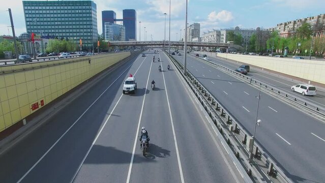Many bikers ride by Leningradskoe highway with car traffic