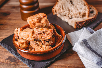 Heap of domestic salty fried pork greaves. Fatty junk food. Pork greaves on the kitchen board.
