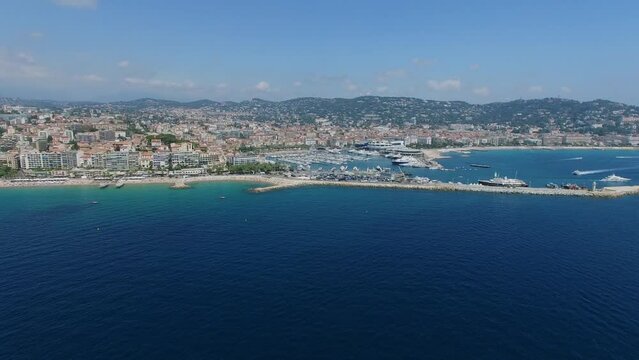 Cityscape with many vessels in Port of Cannes at summer sunny day