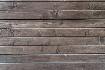 A close-up of dark-stained wooden planks, showcasing natural wood grain and textures perfect for...