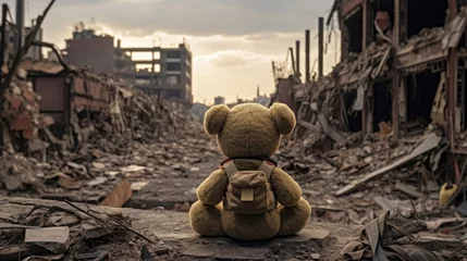 Fotobehang A teddy bear toy over the city burned in the aftermath of war conflict © didiksaputra