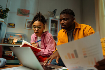 Portrait of serious pensive African American man and woman planning startup sitting on sofa