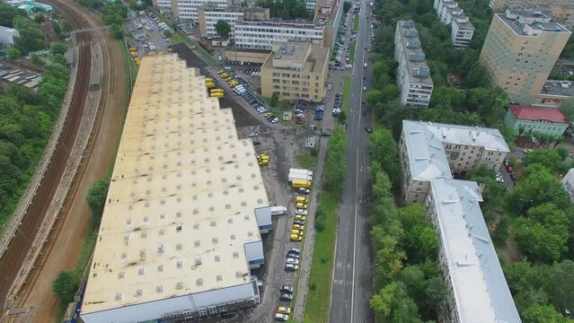 DHL company building and yellow trucks parked near railway and town street