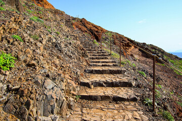Fototapeta na wymiar Stone stairs on the trail to the Ponta de São Lourenço (tip of St Lawrence) at the easternmost point of Madeira island (Portugal) in the Atlantic Ocean