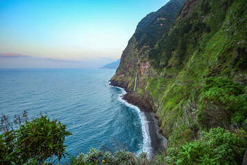 Coastal waterfall of Córrego da Furna on the north coast of Madeira island (Portugal) in the Atlantic Ocean, seen from the Véu da Noiva viewpoint on the abandoned portion of the ER101 coastal route