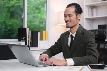 Obraz premium Happy smile professional business man online working, focused ethnic male student working on laptop, remote studying using computer laptop looking at screen watching seminar webinar at home office.