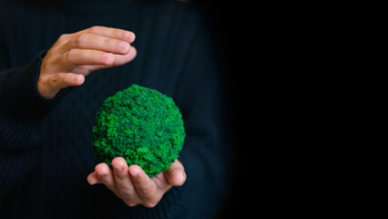 woman hand holding the green grass earth ball in her hands. Earth day. Green concept. Concept for research global warming,climate change, global network,SEO search, ECO and save the world.