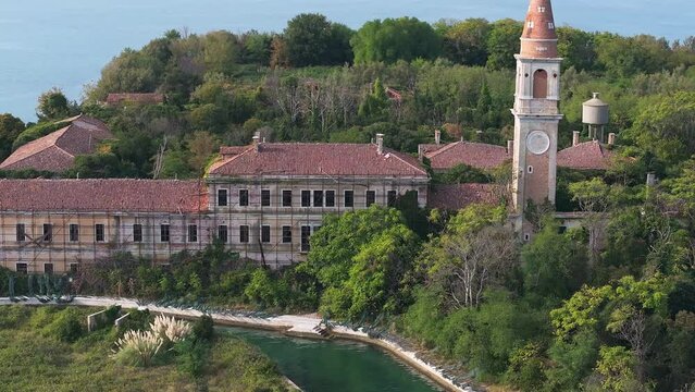Aerial view of the plagued ghost island of Poveglia in the Venetian lagoon, opposite Malamocco along the Canal Orfano near Venice, Italy.