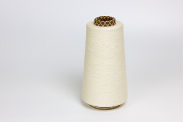 White bobbin of yarn with cones motif isolated on white background 