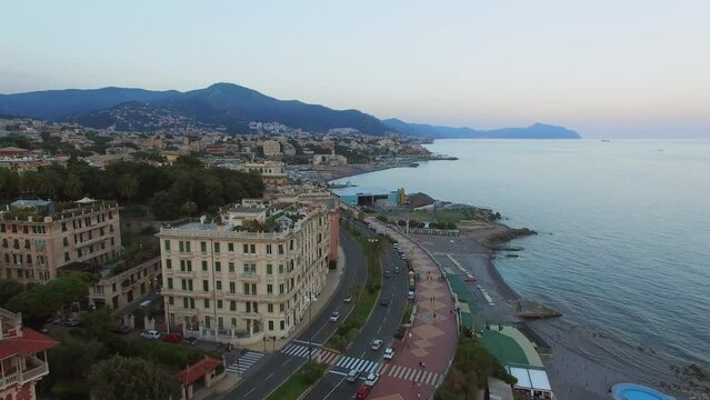 Townscape with traffic on Corso Italia and people walk by quay 