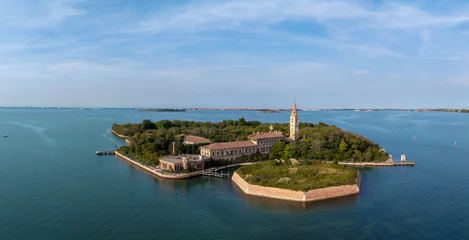 Muurstickers Aerial view of the plagued ghost island of Poveglia in the Venetian lagoon, opposite Malamocco along the Canal Orfano near Venice, Italy. © ingusk