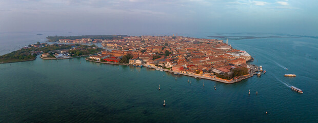 Aerial view of Murano island in Venetian lagoon sea from above, Italy at sunset © Aerial Film Studio