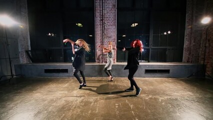 Girls trio perform in original style near large windows