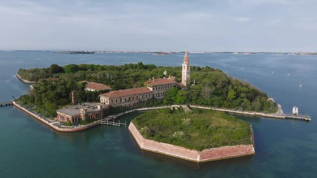 Aerial view of the plagued ghost island of Poveglia in the Venetian lagoon, opposite Malamocco along the Canal Orfano near Venice, Italy.