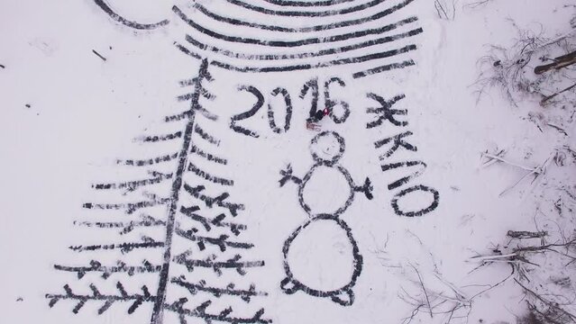 Man with child stand on shapes of fir tree, snowman and inscription of ZHKLO 2016