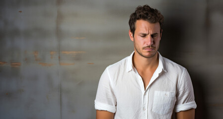 Obraz premium Portrait of a handsome young man in white shirt, indoor.