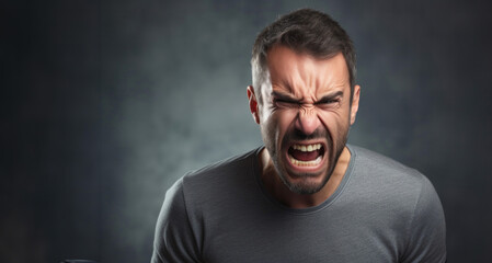 Portrait of angry man screaming on dark background. Emotions concept