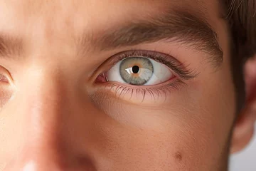 Möbelaufkleber Close-up of a young man's eye with blue iris © YannTouvay
