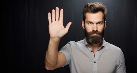 Man with beard and mustache making stop gesture with his hand on black background - obrazy, fototapety, plakaty