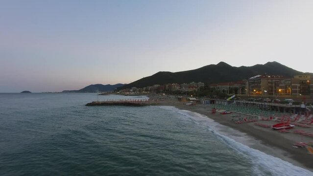 Loano, Italy, Empty sunbeds and parasols on sea beach at summer