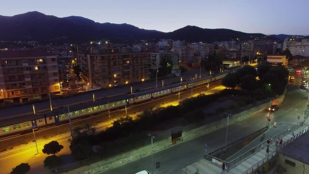 Loano, Italy, Cityscape with passengers train and street with people 