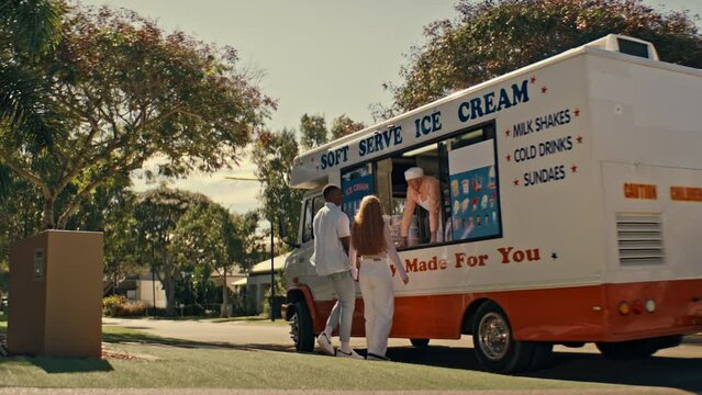 interracial couple buying ice cream from the ice cream Van
