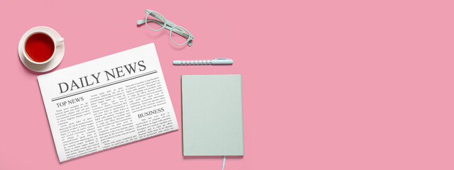 Newspaper with cup of tea, eyeglasses, notebook and pen on pink background with space for text