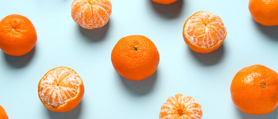 Many tangerines on light blue background. Pattern for design