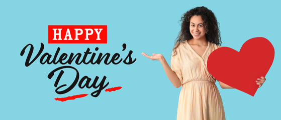 Beautiful young African-American woman with red paper heart on light blue background. Banner for Valentine's Day