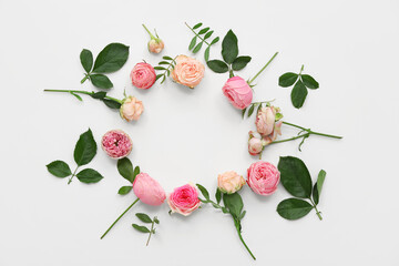 Frame made of beautiful pink roses with leaves on white background