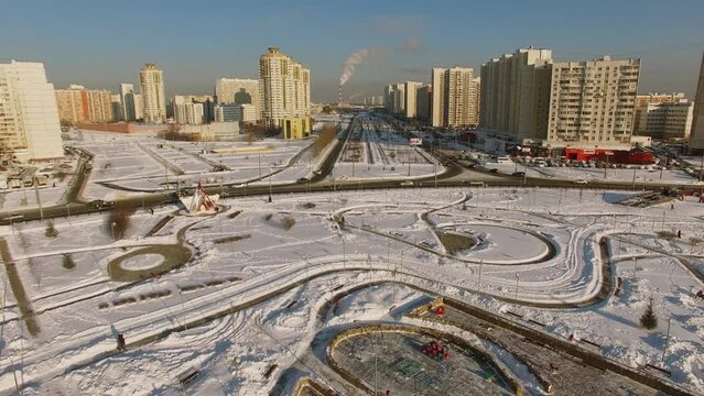 Megalopolis with road traffic near park among residential houses