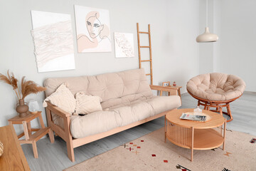 Interior of stylish living room with paintings, sofa and armchair