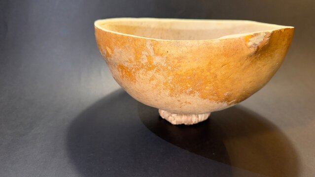 close-up of a typical container made from the fruit of the tecomate or morro tree.  black background with copy space