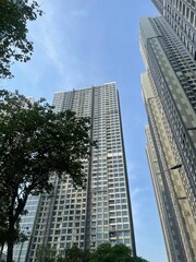 Obraz premium Skyscrapers in city,Full frame shot of building, View of cityscape against sky during sunset,Vehicles on road in city against sky.Buildings in city against cloudy sky Sunset behind the new skyline 