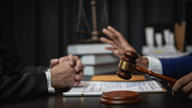 good customer service Businessman consulting with male lawyer or judge consulting in team meeting with client with hammer and scales next to close-up image legal concept