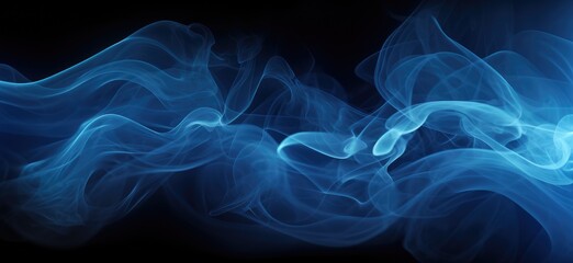 Fototapeta premium This photo shows a textured blue smoke billowing against a black background.