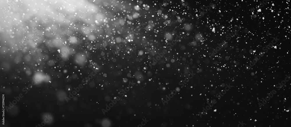 Poster overlay abstract black texture with falling snowflakes onto any object against a real snow backgroun
