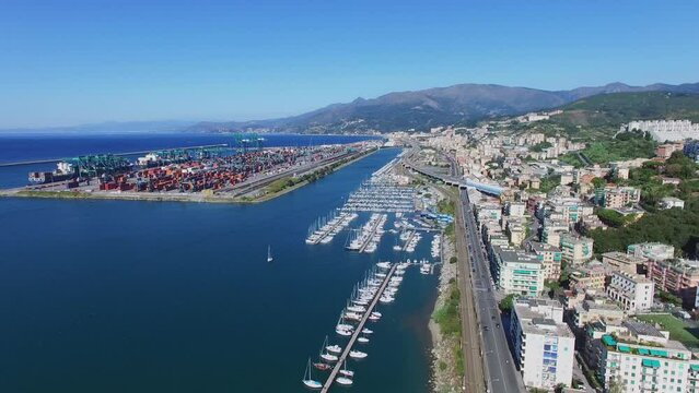 Genoa, Italy, townscape with highway traffic near many boats 