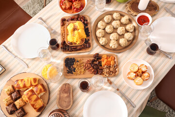 Traditional Eastern dishes for Ramadan on dining table in room, top view