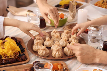 Muslim family having dinner at home, closeup. Ramadan celebration